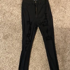 Distressed black skinny jeans